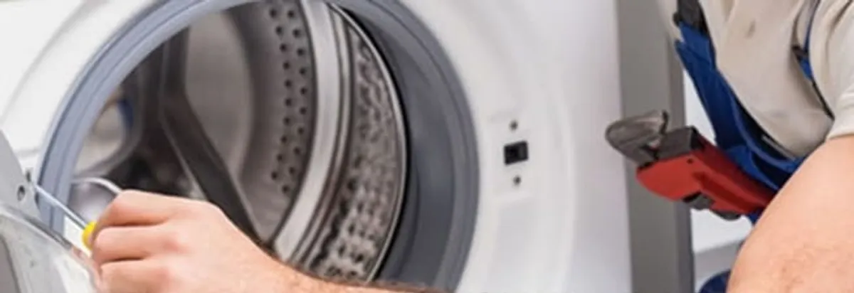 Appliance technician repairing a clothes dryer drum and internal parts in Richmond, VA