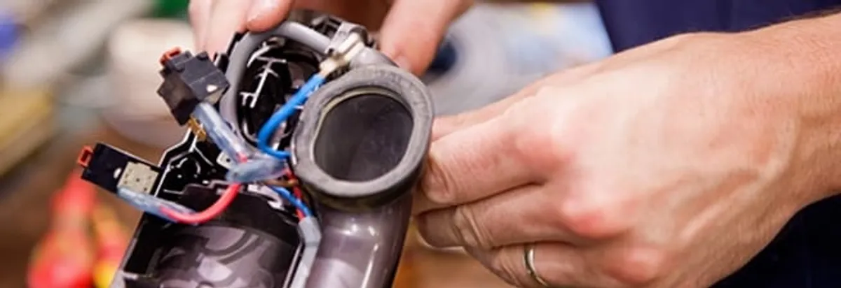 Vacuum repair technician reconnecting wiring and components in Richmond, VA